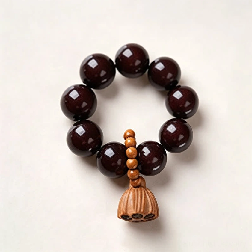 Black bodhi seed meditation bracelet with hand-polished round beads and wooden lotus charm detail