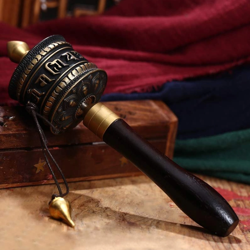 Black bronze Buddhist prayer wheel with engraved Om Mani Padme Hum mantras, brass tassel, dark wood handle meditation decoration