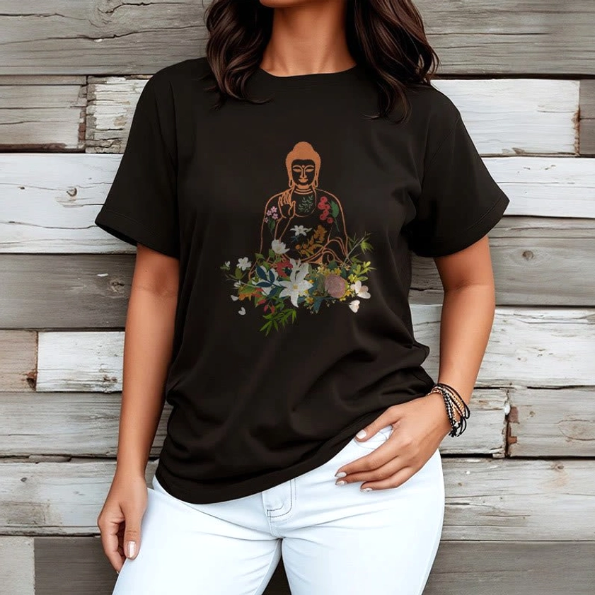 Female model wearing black Buddha flower print t-shirt wooden plank background - relaxed fit spiritual tee