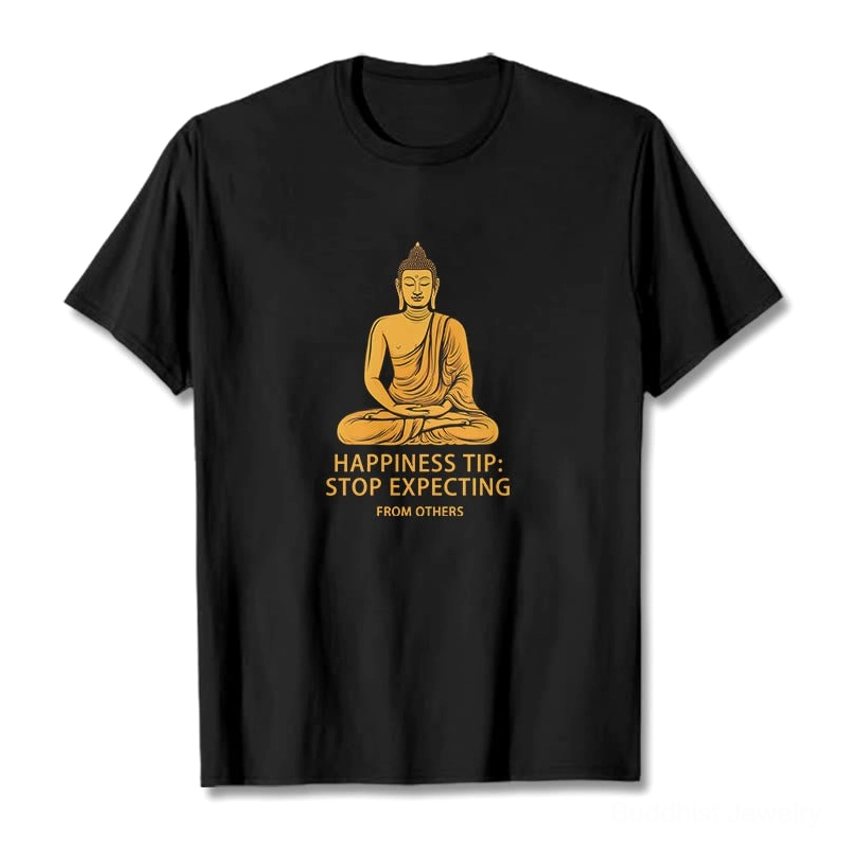 Black Buddha mindfulness graphic t-shirt with golden seated Buddha print and 'Stop Expecting From Others' text, front flat lay view on white background