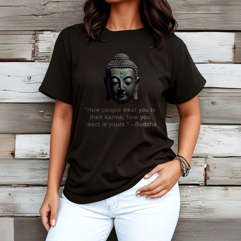 Black Buddha karma quote t-shirt women's fit on female model with white jeans wooden background