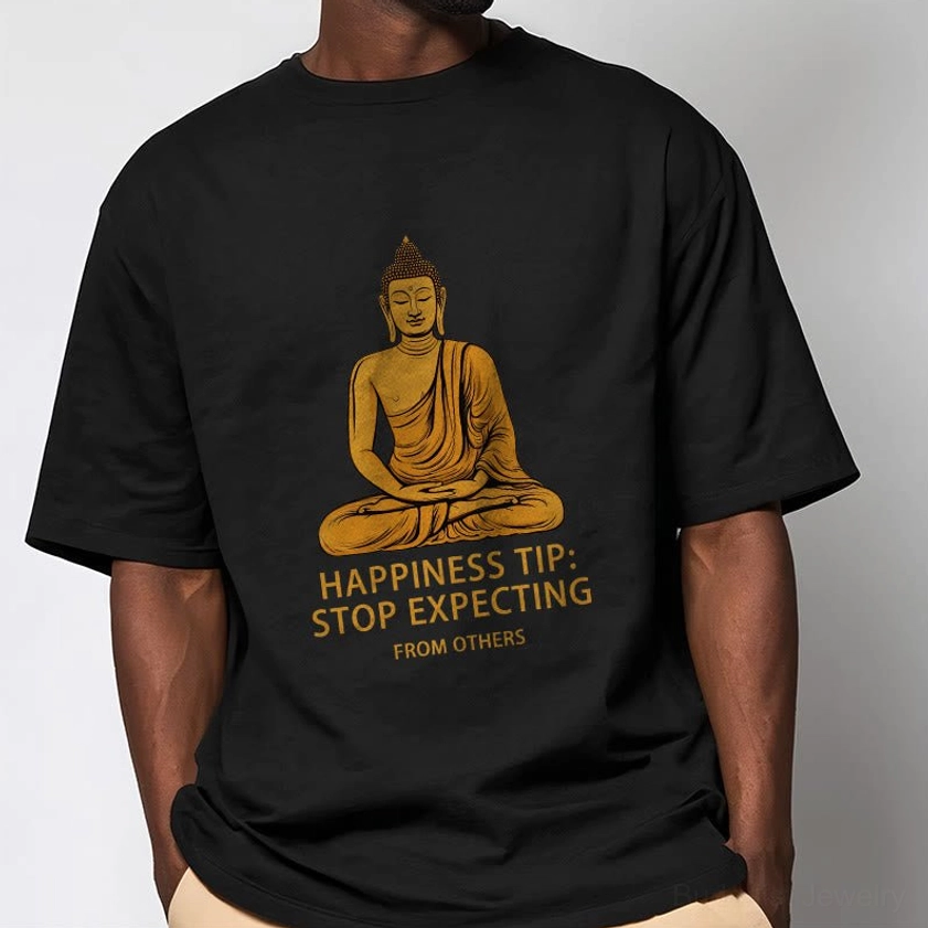 Male model wearing black Buddhist graphic tee with golden Buddha print, half-body front view on light grey background