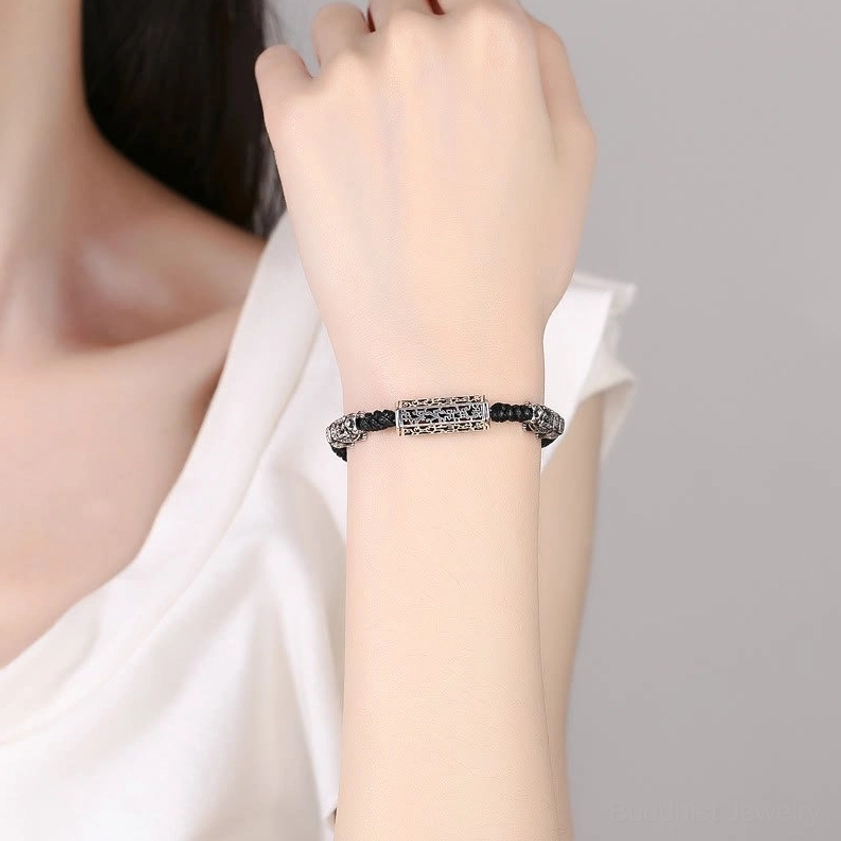 Woman wearing black copper Buddhist protection bracelet on wrist daily wear example