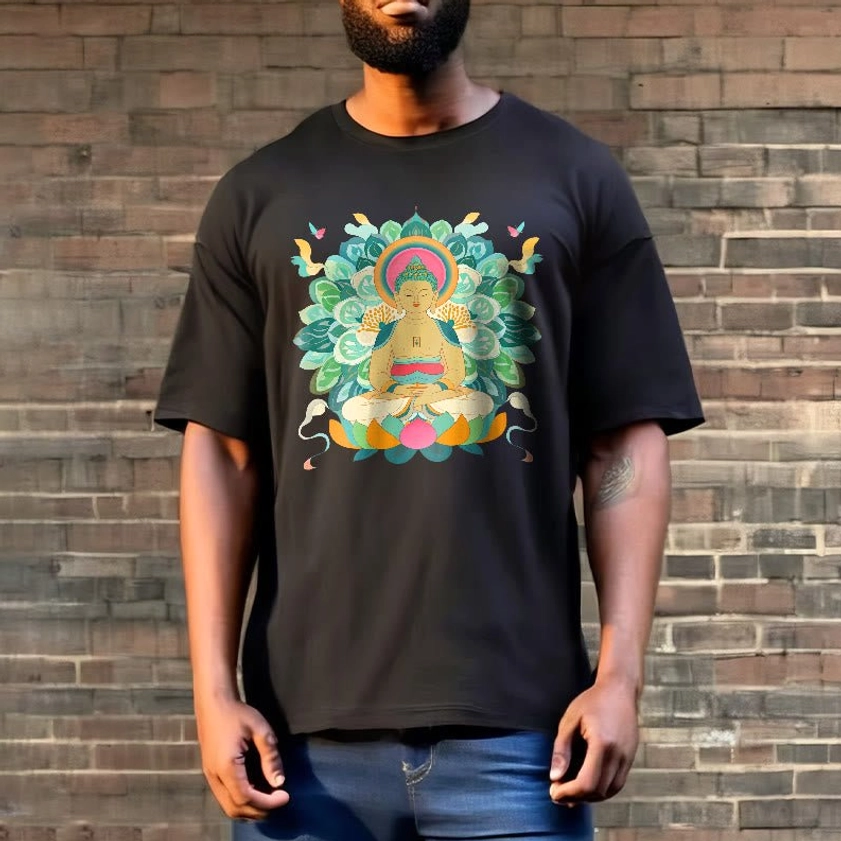 Man in black Buddhist graphic t-shirt with Buddha lotus design wearing blue denim pants brick wall