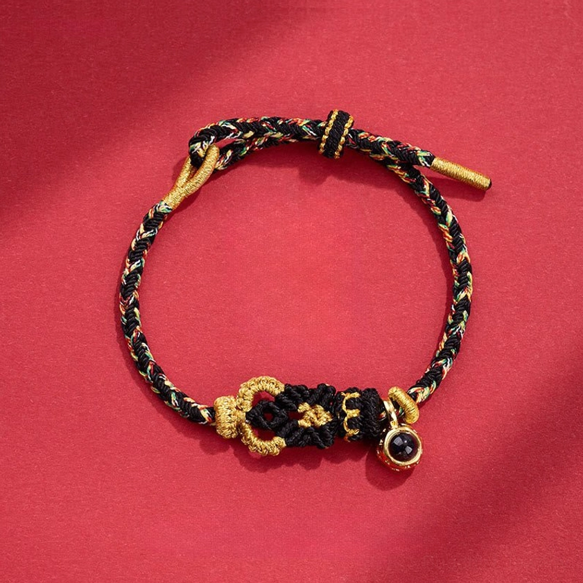Black Buddhist string bracelet with hand-woven Buddha knot for spiritual protection and grounding