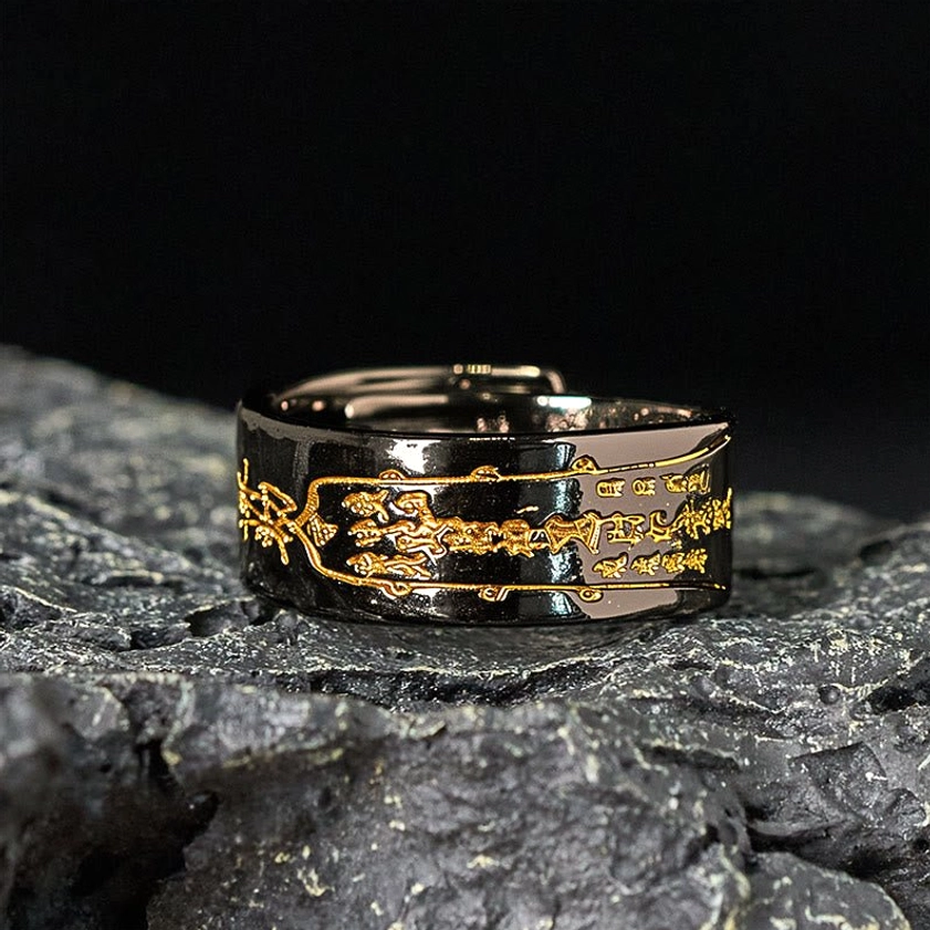 Black polished copper talisman ring front overhead view displaying gold-accented engravings and premium finish quality