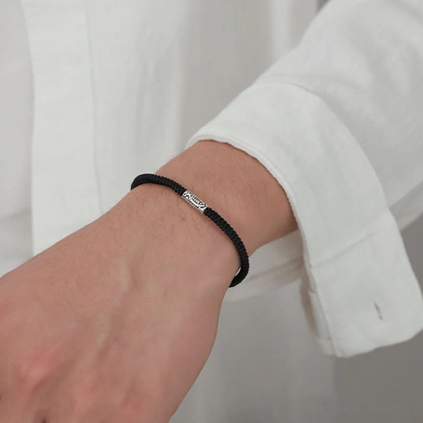 Koi fish bracelet worn on male wrist with white shirt showing slim minimalist casual fit