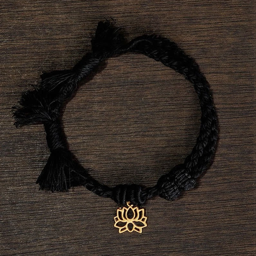 Black lotus bracelet flat lay displaying dark cord with gold lotus pendant for alternative color option