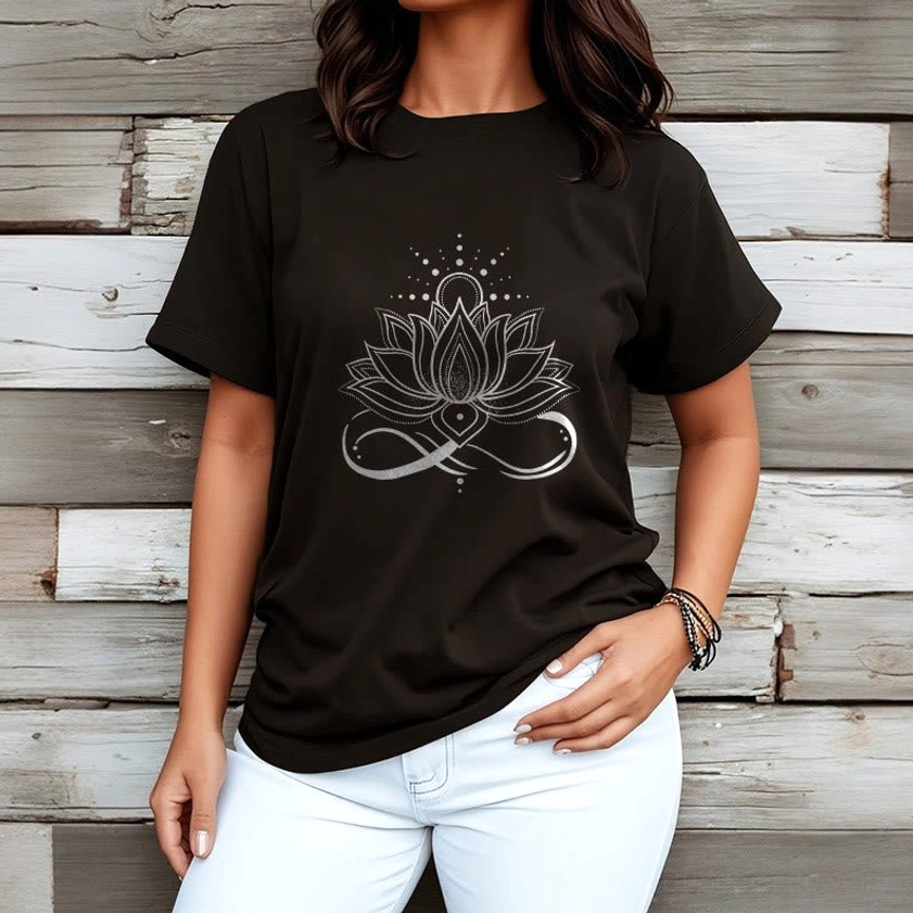 Black lotus flower Buddhist t-shirt worn by female model with white pants and spiritual bracelet accessories