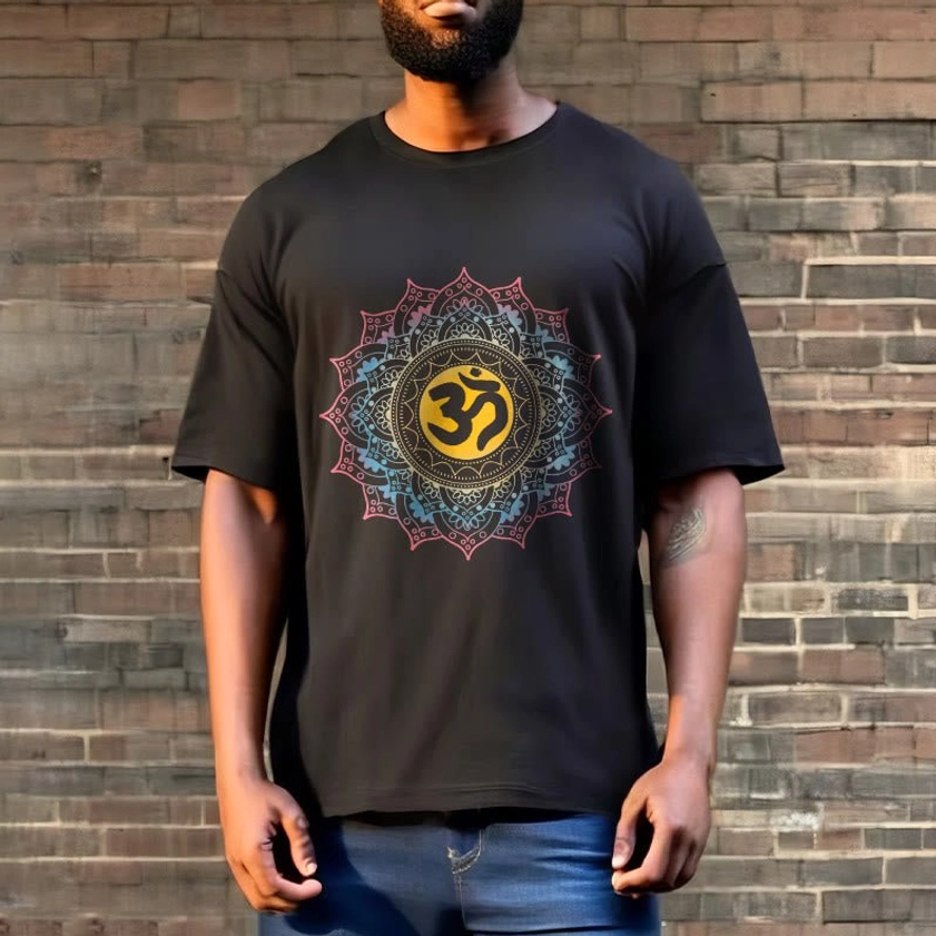 Full body men's black mandala OM Buddhist graphic t-shirt with blue denim, outdoor brick wall backdrop