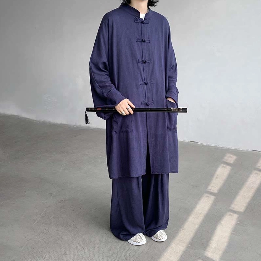 Black Buddhist meditation wear detailed view showing frog button stand collar and fabric texture