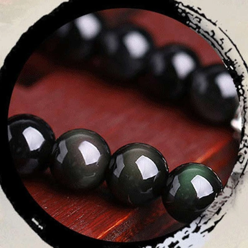 Black obsidian polished beads macro photography smooth glossy surface texture detail