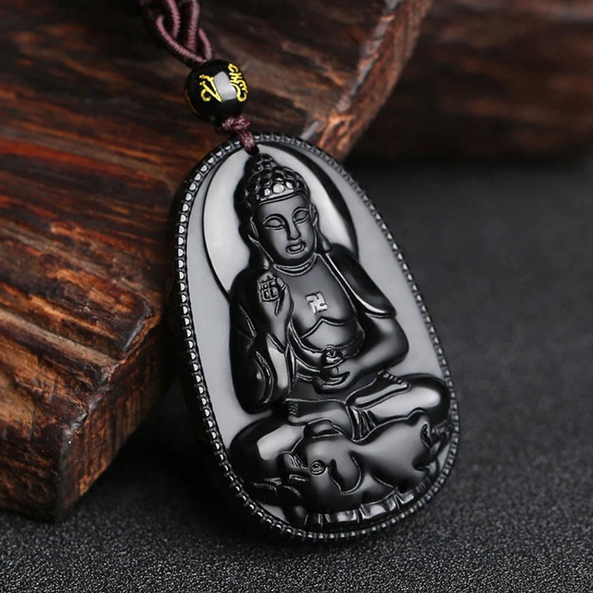 Polished black obsidian Buddhist protection necklace with detailed guardian Buddha pendant, oblique angle view