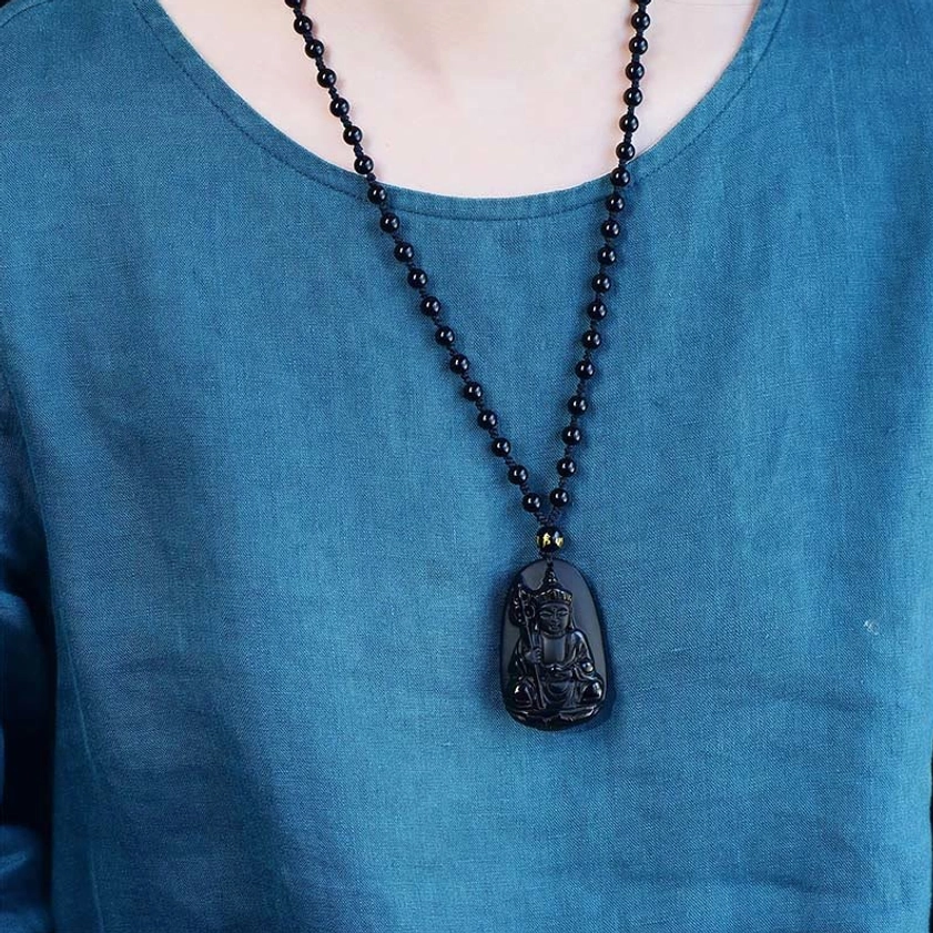 Woman wearing black obsidian Buddhist necklace pendant on chest for daily spiritual practice