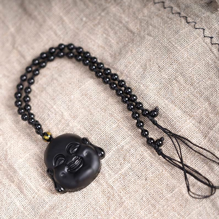 Black obsidian laughing Buddha pendant necklace with adjustable braided black cord and gold spacer bead