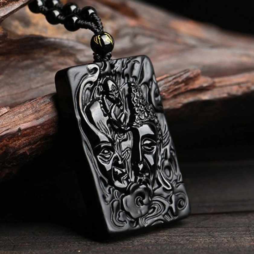Black Obsidian Buddha Pendant - Three-Quarter Side View Showing Intricate Relief Carving