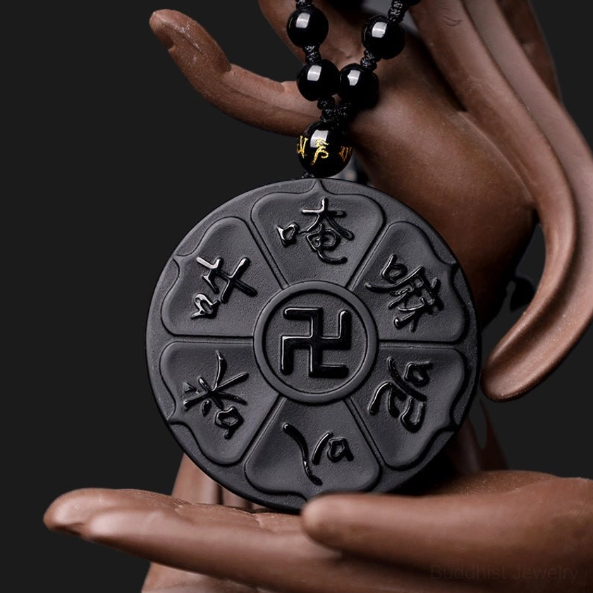 Three-quarter view of black obsidian necklace pendant with branded spacer bead on chain