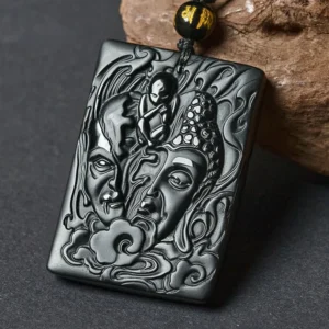Half demon half buddha black obsidian pendant necklace with hand-carved relief design and waxed cotton cord
