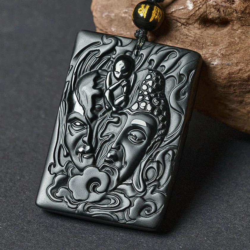 Half demon half buddha black obsidian pendant necklace with hand-carved relief design and waxed cotton cord