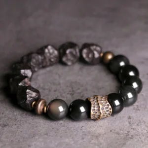 Black obsidian ebony wood copper couple bracelet - flat lay top view showing matched pair design with smooth obsidian beads, carved ebony wood, and bronze metal accents