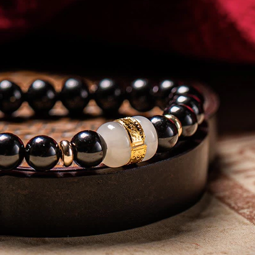 Black obsidian and jade Buddhist couples bracelet for meditation and mindfulness practice, showing unisex design suitable for all wearers