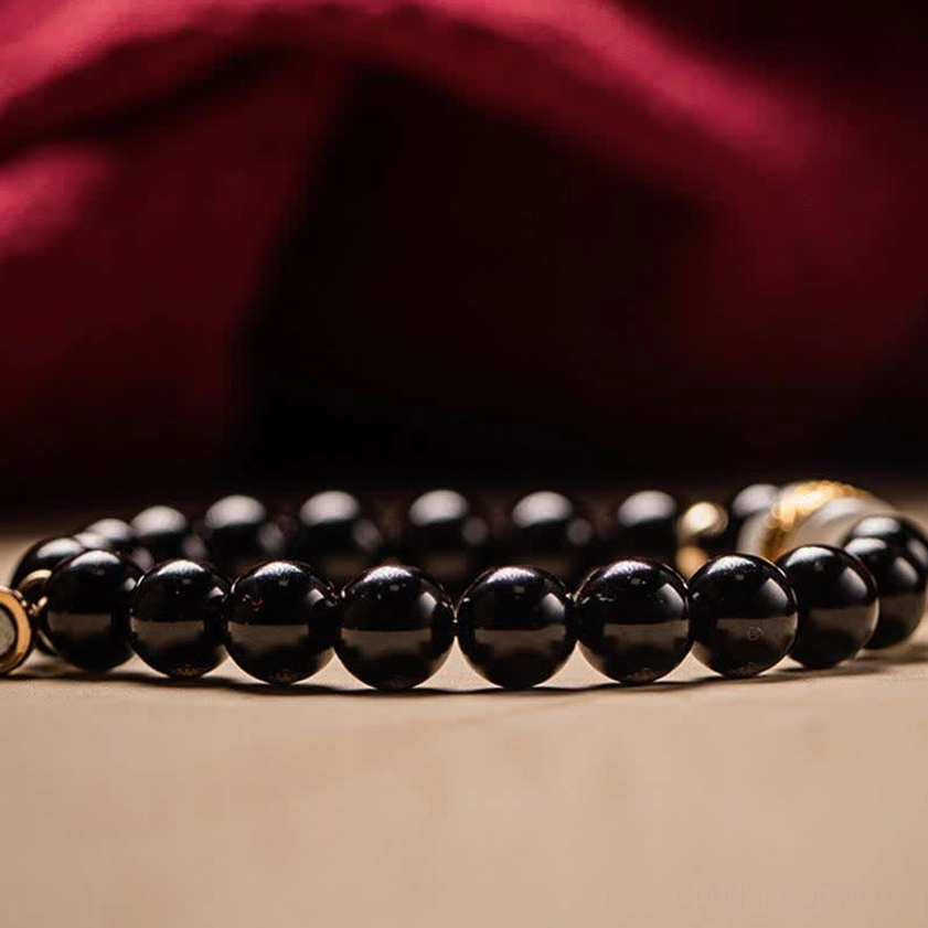 Black obsidian and jade om mani padme hum bracelet as meaningful gift for spiritual seekers and Buddhist practitioners