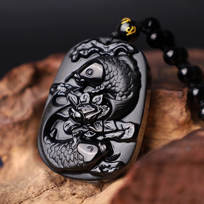 Black Obsidian Koi Lotus Pendant Necklace - side three-quarter angle showing hanging beaded chain with glossy stone finish