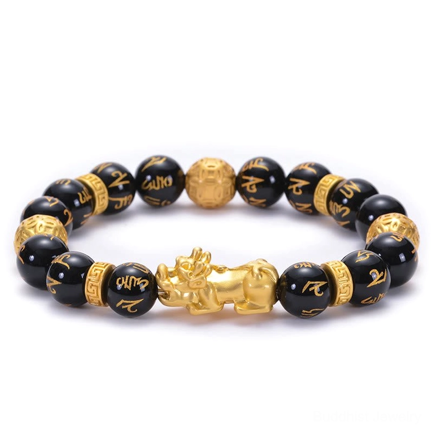 Black obsidian Buddhist bracelet with engraved Om Mani Padme Hum mantra beads and gold PiXiu charm, top-down flat lay view