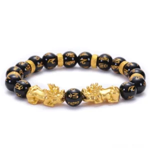 Black Obsidian Pixiu Om Mani Padme Hum Buddhist bracelet overhead view with golden charms and engraved beads