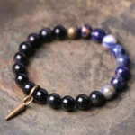 Black Obsidian and Sodalite couples crystal bracelet with copper spike pendant - top-down close-up view