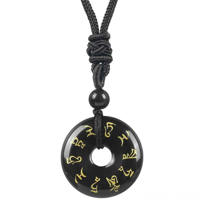 Black Obsidian Green Tara mantra donut pendant close-up with golden Sanskrit text and black woven cord necklace