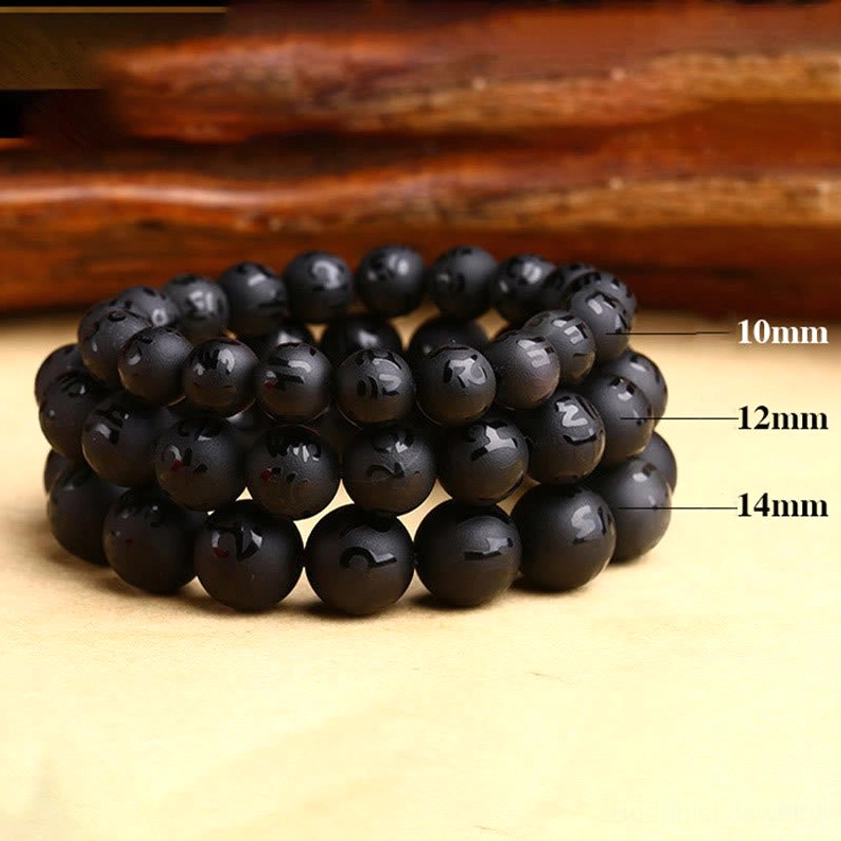 Black onyx bracelets in multiple sizes comparison - 10mm, 12mm, and 14mm bead sizes on wooden background, showing variety of Buddhist bracelet options