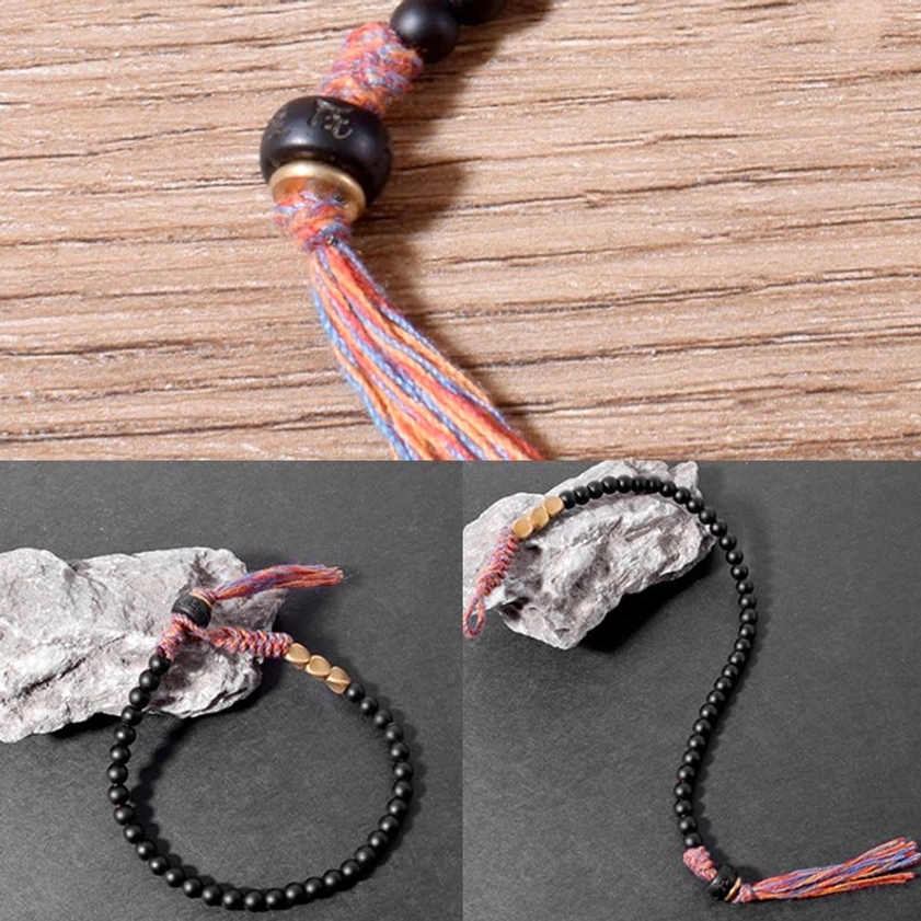 Dual angle display of black onyx tassel bracelet showing both looped and extended wearing styles on mixed stone and wood backgrounds