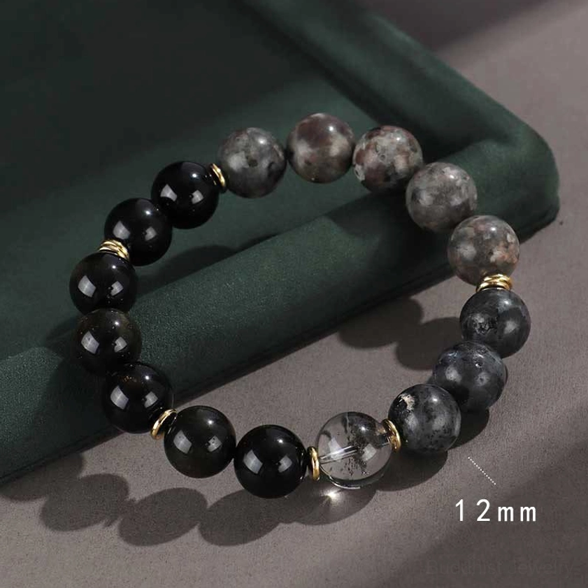 black onyx healing crystal buddhist bracelet with silver spacers and cloudy quartz on dark velvet display