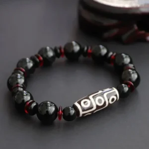 Black Onyx Nine-Eye Dzi Bead Bracelet front view with white hand-painted dzi bead and red spacers