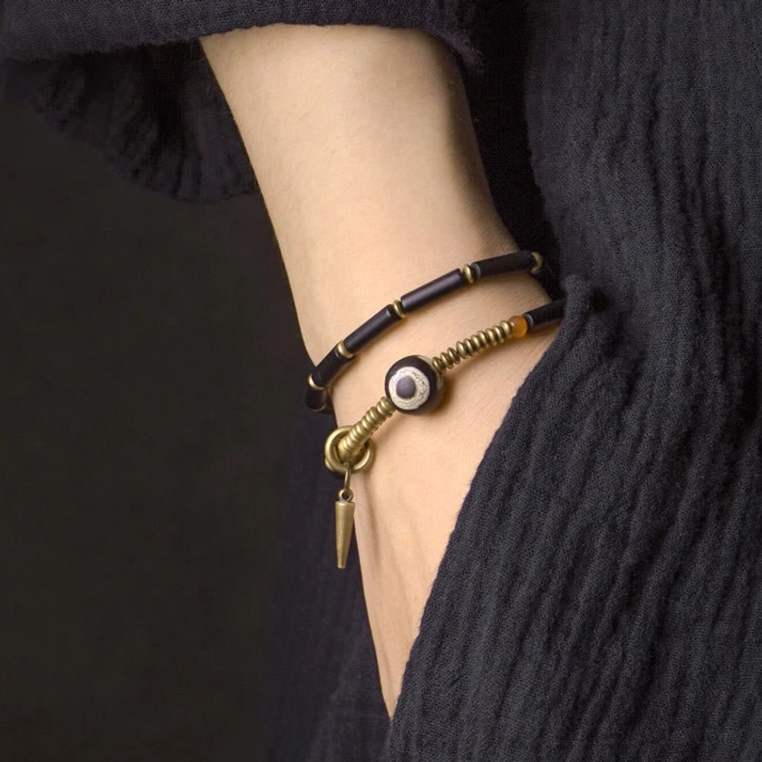 Double wrap black onyx bracelet worn on wrist showing layered spiritual protection jewelry design