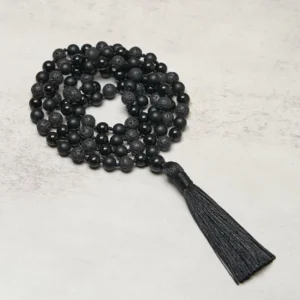 Black Onyx and Lava Rock 108 bead mala necklace with tassel, top-down view showing mixed matte and polished gemstone beads