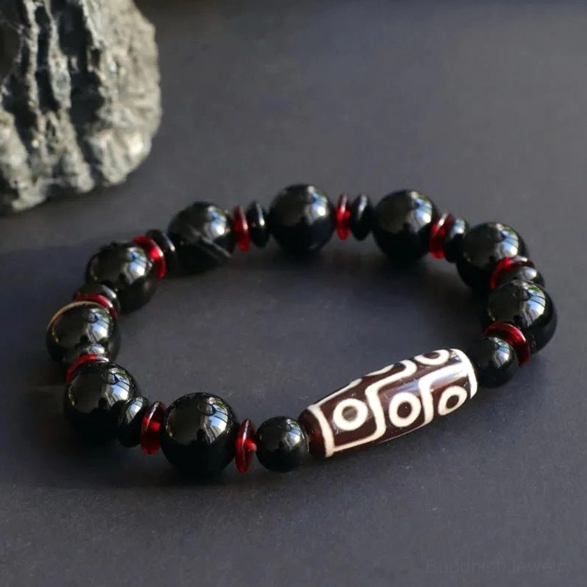 Black Onyx Nine-Eye Dzi Bead Bracelet flat lay top-down view with uniform beads