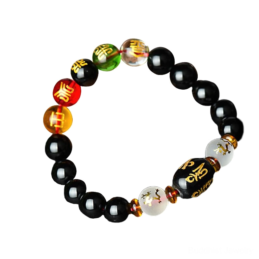 Complete view of black onyx Buddhist bracelet with engraved mantra focal bead and natural gemstone beads on dark background