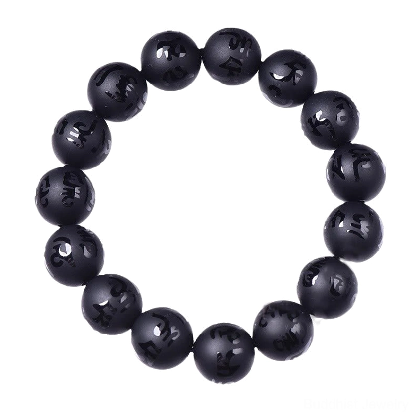 Single black onyx Om Mani Padme Hum mantra bracelet on light background, round matte black beads with carved Sanskrit text and elastic cord design