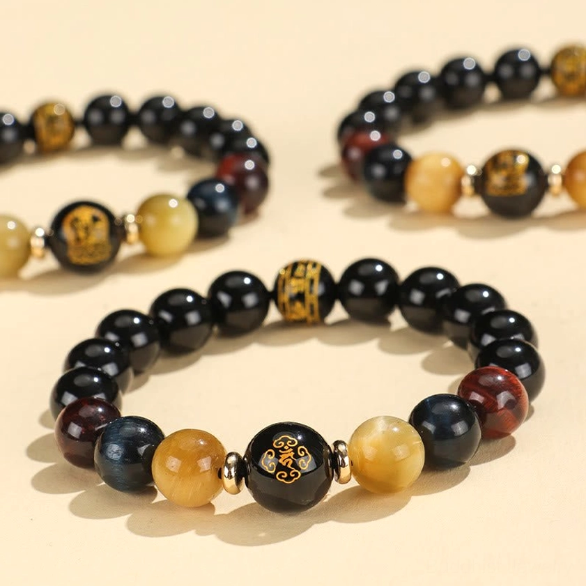 Black onyx tiger eye Buddhist bracelet with Om Mani Padme Hum mantra bead and Chinese zodiac natal Buddha charm, multi-angle overhead view
