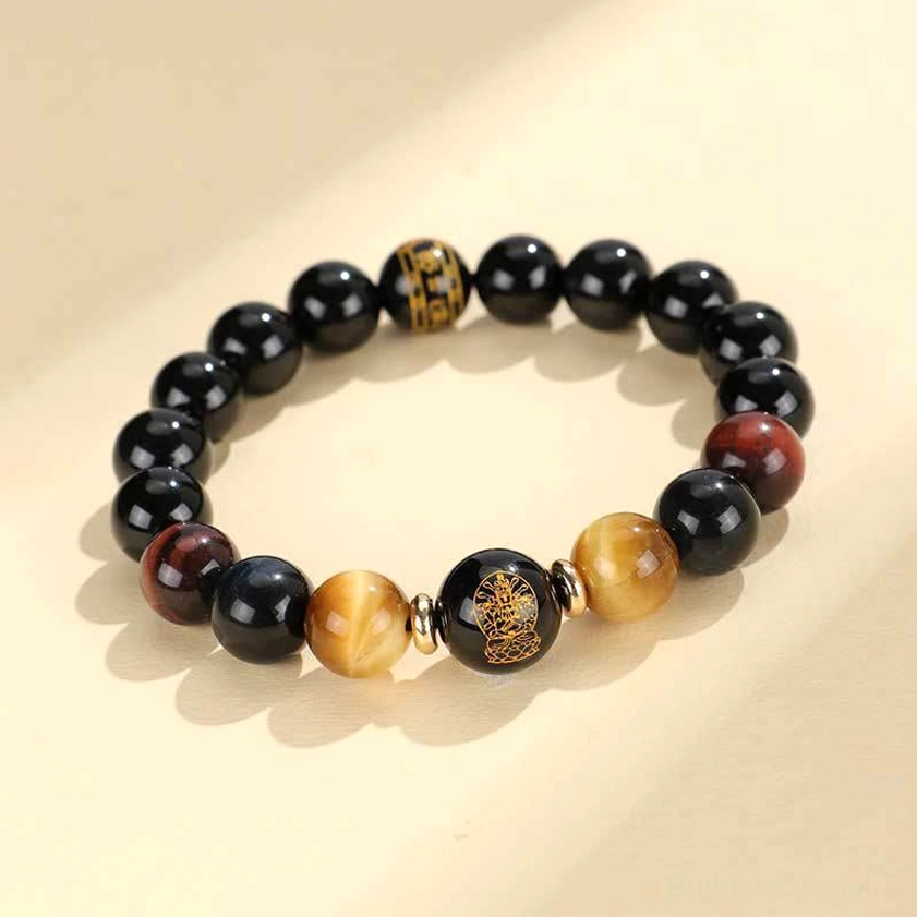 Single strand black onyx tiger eye Buddhist bracelet with engraved Om Mani Padme Hum mantra bead, front view