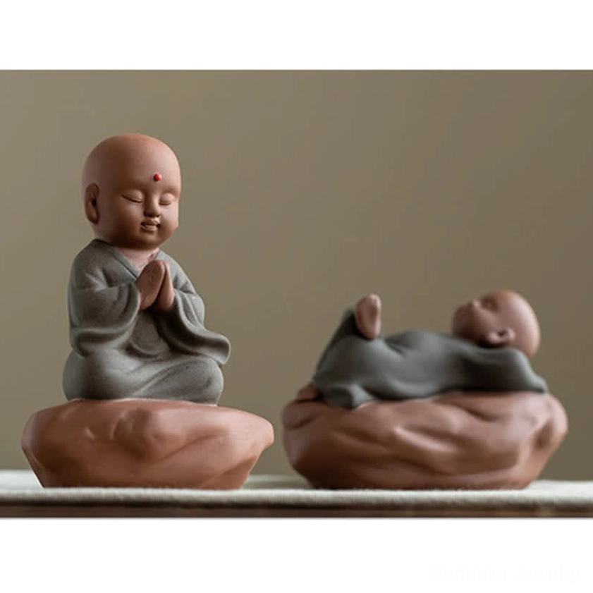 Black peach wood Buddha meditation figurine with spiritual altar arrangement and prayer beads