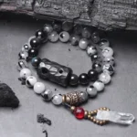 Black Rutilated Quartz White Crystal Buddhist couple bracelet flat lay top view with ebony wood charm