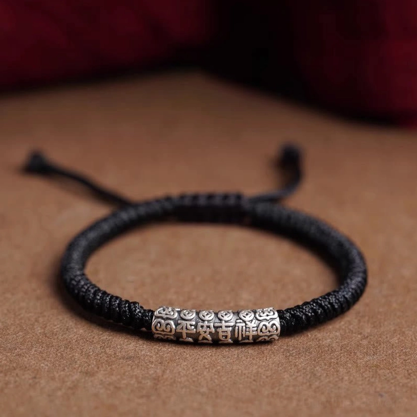 Black Buddhist string bracelet with peace and good fortune engraved silver charm