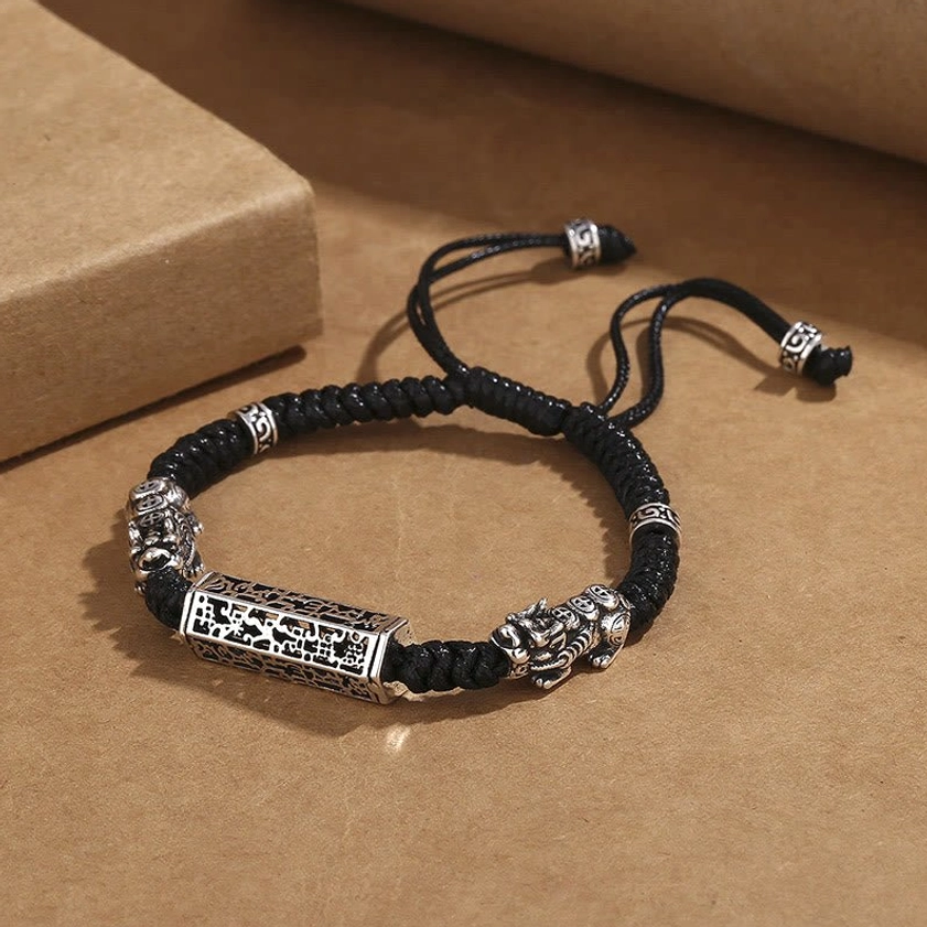 Adjustable black string copper Buddhist protection bracelet with Pixiu charm side view
