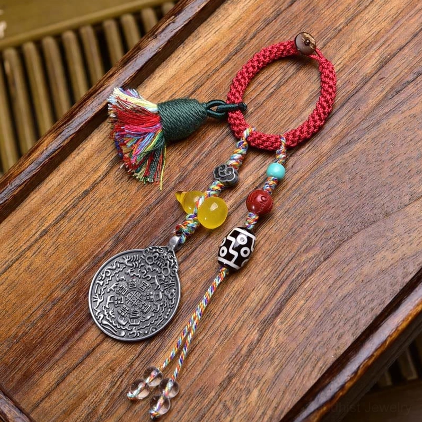 Black and white Dzi Bead keychain featuring hand-painted sacred patterns with red rope and silver charms