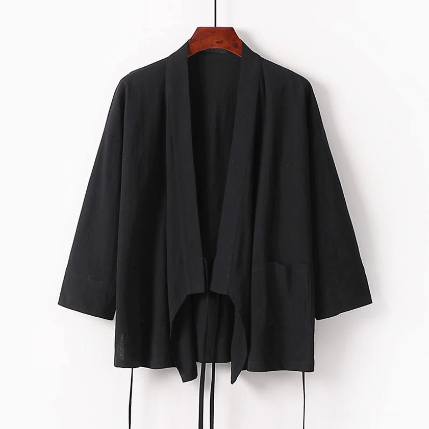 Black wrap kimono meditation top with tie closure and side pocket hanging display
