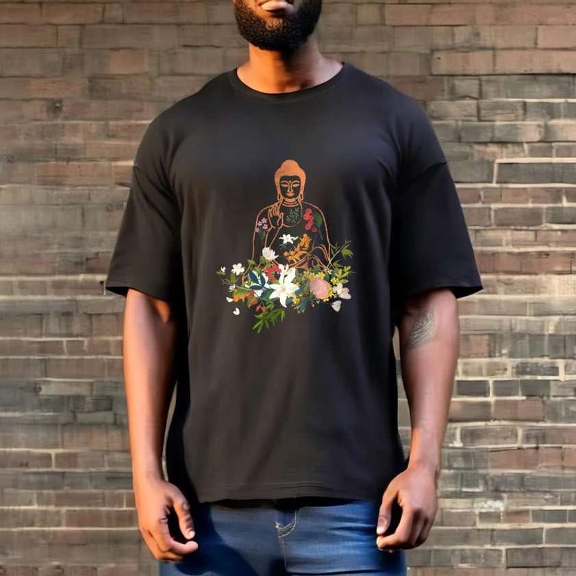 Male model in black Buddhist zen floral t-shirt standing against brick wall outdoor - spiritual casual style