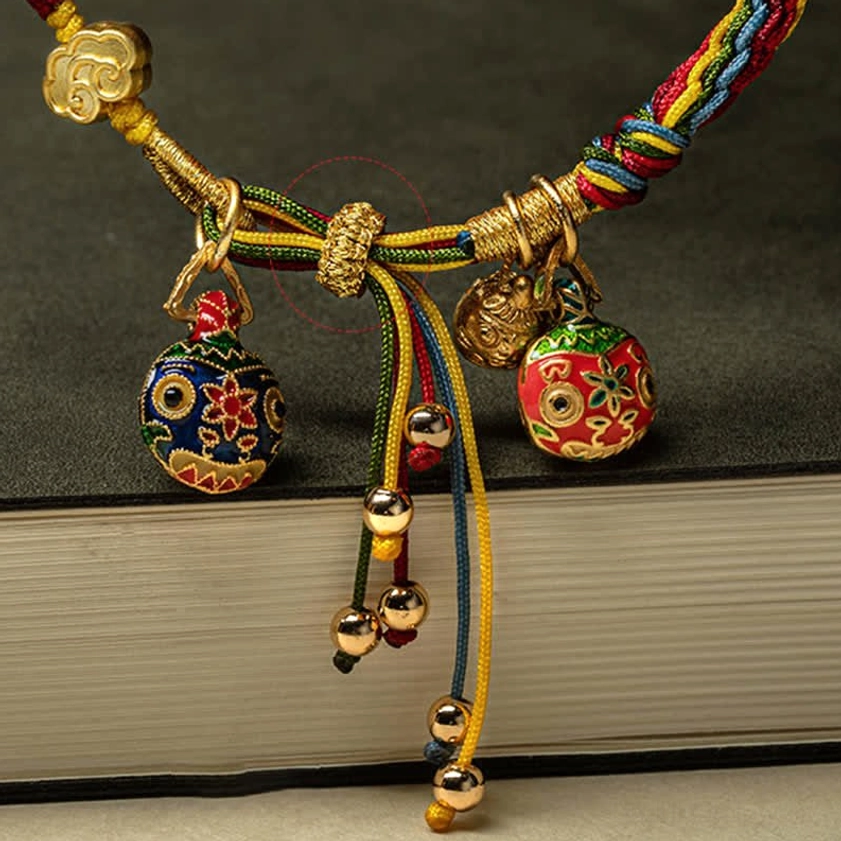 Buddhist Swallowing Beast fortune bracelet with enamel charm and gold hardware detail shot